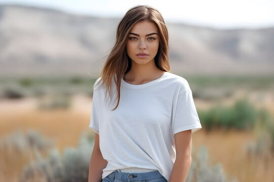 Young blond boho girl model at the age of 20s standing with some blurry scenery behind with a clean white t-shirt, concept of t-shirt mockup