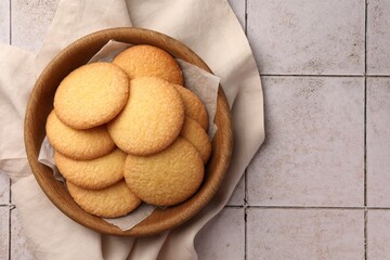 Delicious Danish butter cookies on white tiled table, top view. Space for text