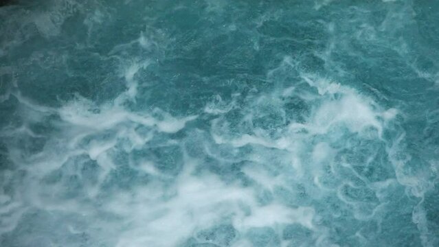 turbulent flow of pure glacial water. blue water seething after the waterfall. summer travel. hiking in Montenegro.