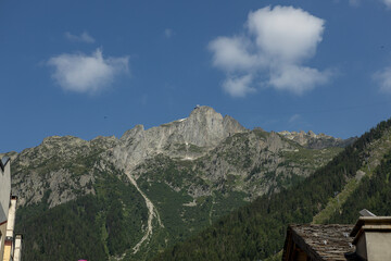 Rock mountain top above against a blue sky in tourist destination winter sports town Chamonix in French alps