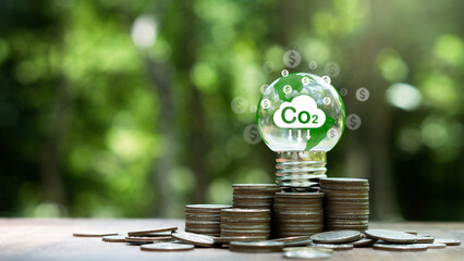 Carbon credit and tax concept.light bulb with Co2 credits,tax icon.Legal regulation to reduce...
