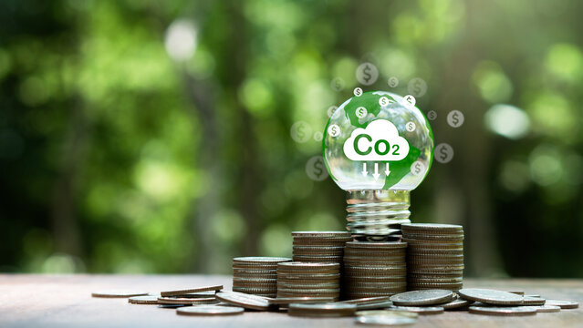 Carbon credit and tax concept.light bulb with Co2 credits,tax icon.Legal regulation to reduce greenhouse gas emission and atmosphere air pollution.