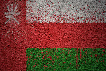 painted big national flag of oman on a massive old cracked wall