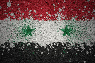 painted big national flag of syria on a massive old cracked wall