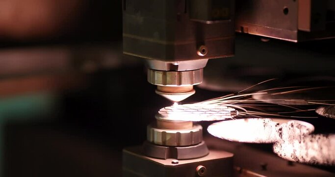 Sparks from automatic laser cutting or engraving of parts 4k movie. Laser cutting metal concept