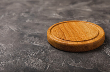 Cutting board on a textured table. Pizza board. Kitchen wooden cutting board and kitchen towel. Kitchenware. Menu. Recipe. The concept of cooking. Mockup