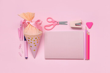 Obraz na płótnie Canvas School cone with different stationery on pink background