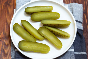 Pickled cucumbers close-up, snack. Selective focus. Ingredients for cooking on a wooden table.