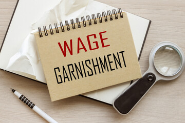 Wage Garnishment. craft notepad with a spring. text on the page