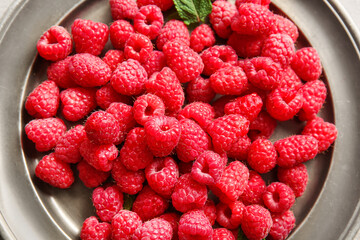Plate with fresh raspberries, closeup