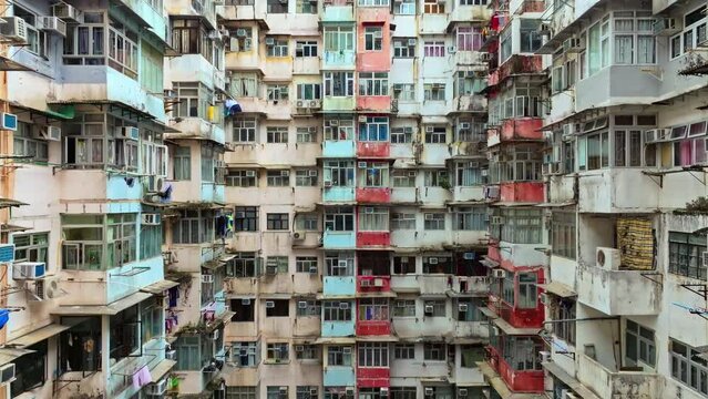 Yick Cheong and Yick Fat old apartment house exterior architecture in Hong Kong city, drone aerial view. Asian people residential life, transformer building or monster building travel landmark