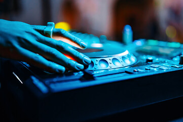 woman DJ Hands creating and regulating music on dj console mixer in concert