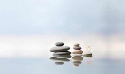 Fototapeta premium Zen yoga and spa stones treatment scene, zen like concepts. woth waterlily in beautiful calm landscape with blurred background, natural therapy massage stones relaxtion