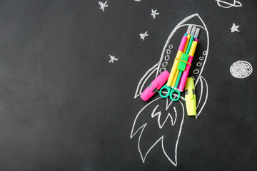 Drawn rocket with stationery on black background © Pixel-Shot