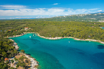 Obraz premium Aerial view of the rocky and forested coast of Rab Island, the Adriatic Sea in Croatia