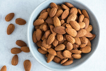 Dry roasted almonds in a bowl, top view