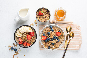 Fototapeta na wymiar Granola with berries, banana and almond milk on a table, top view. Flat lay composition