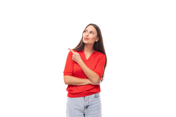 portrait of a cute young european brunette lady in a red t-shirt actively gesturing with her index finger towards the wall