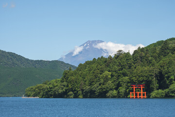 Torii gate in Japanese temple gate at Hakone Shrine with Fuji mountain background near lake Ashi at...
