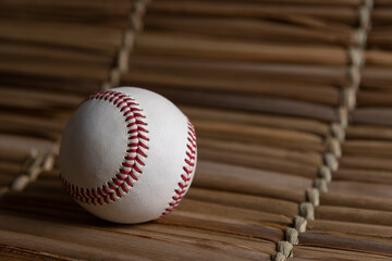 Baseball ball on straw background