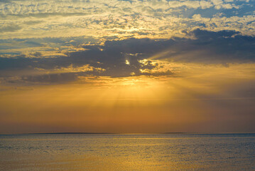 Naklejka premium A beautiful sunset on the sea is reflected in the water.