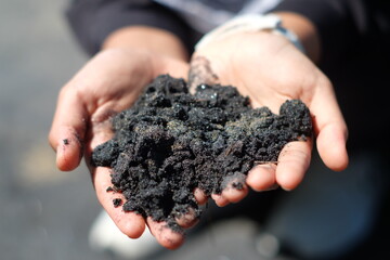 Handing black sand in Black sand beach in Phangnga - Thailand 