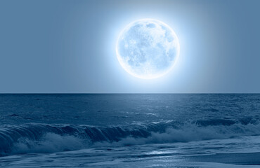 Naklejka na ściany i meble Night sky with blue moon over the calm blue sea 