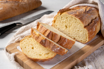 Bakery - Freshly baked bread on rustic wooden background. Sliced ​​bread. 