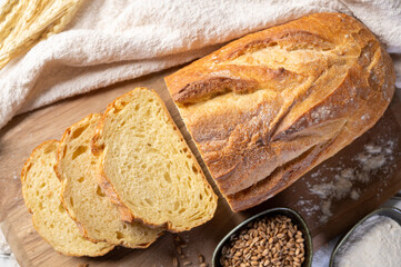 Bakery - Freshly baked bread on rustic wooden background. Sliced ​​bread. Top view.