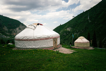 Kazakh traditional yurt in mountains. Outdoor camping in traditional yourt concept. Travel in Kazakhstan.