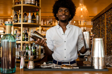 young and happy latin bartender with curly hair