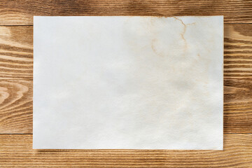 Sheet of paper lying on wooden table