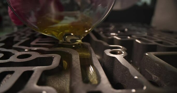 Oil is poured into valve body of automatic gearbox transmission