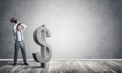 Determined banker man in empty concrete room breaking dollar figure