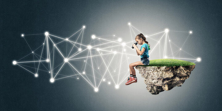 Concept of careless happy childhood with girl looking in binoculars