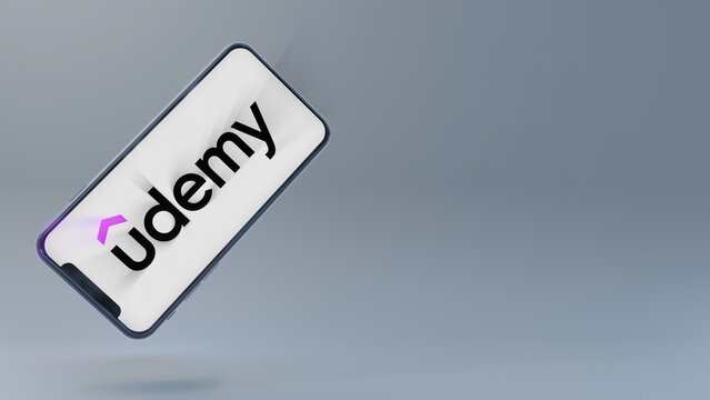 Udemy logo beaming out of floating smartphone. Editorial illustration
