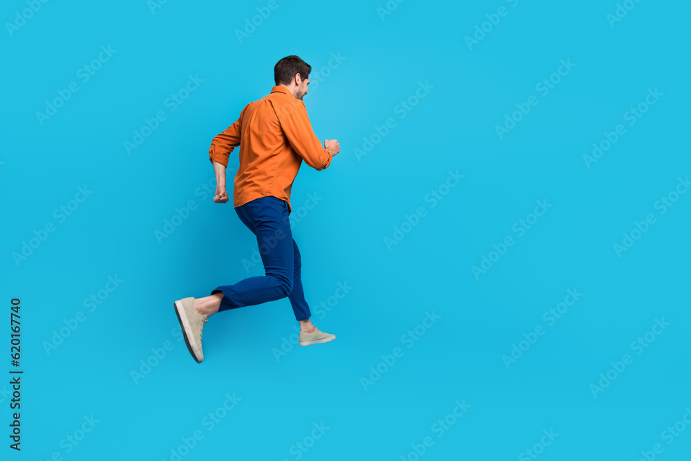 Poster full size profile rear portrait of energetic crazy young man jumping running empty space advert isol