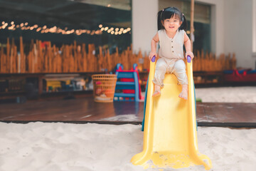 Asian girl play slider at outdoor playground, Cute child happy preschool little kid having funny...