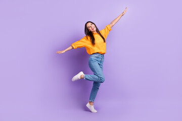 Full size photo of good mood lovely cute woman dressed oversize shirt flying hold arms like wings isolated on violet color background