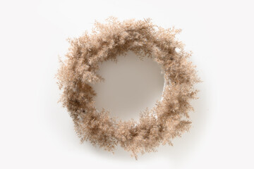 Thanksgiving wreath with dry natural materials isolated on white background. Top view. Copy space. Minimalism.