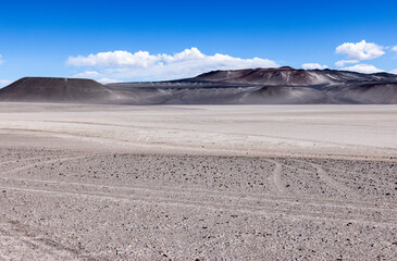 Fototapeta na wymiar Puna - off road adventure on the way to the Campo de Piedra Pómez, a bizarre but beautiful landscape with a field of pumice, volcanic rocks and dunes of sand in the north of Argentina, South America 