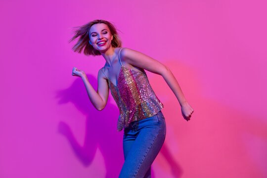 Photo of positive cheerful lady dance energetic dynamic on nightlife party event isolated vibrant neon color background