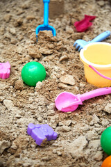 Fototapeta na wymiar Children's sandbox with toys for the game in summer day