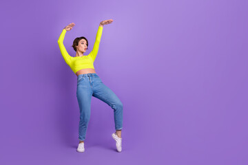 Fototapeta na wymiar Full size portrait of excited pretty girl dancing hands make moves empty space ad isolated on purple color background