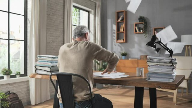 financial problem concerned man sits in the home office looking at bills bank payments gets upset angry