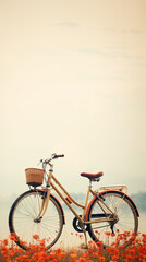 Vintage old bicycle with small basket standing among red flowers, water and sky in the background, wallpaper with copy space. 