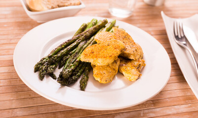 dietary meal rich in protein. Stir fried chicken breast and green asparagus