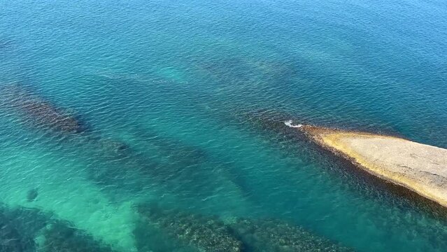 Turquoise blue sea water and rocky coast.