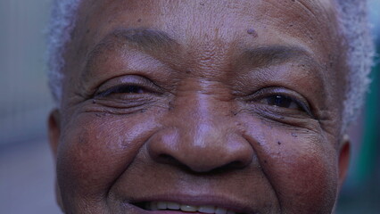 Macro close-up of a joyful black Brazilian woman eyes smiling at camera