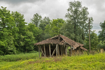 Old rural farm barn in summer day